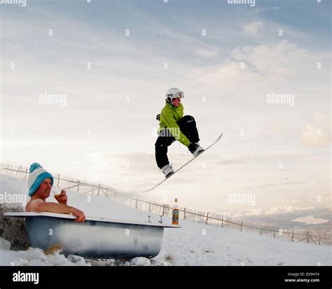 Naked Man In Bath Tub On Top Of A Mountain Wearing Woolly Hat During Scottish Winter Stock Photo