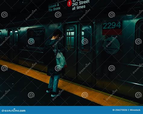 Person Standing In Front Of Train Doors In A Underground Subway Stock