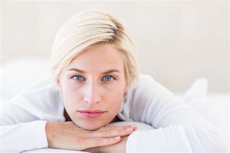 Premium Photo Smiling Blonde Woman Lying On The Bed