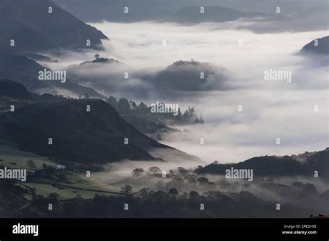 Snowdonia dramatic sunrise with mist in valley below Stock Photo - Alamy