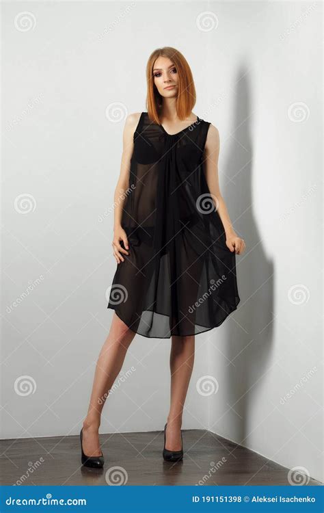 Fashion Model In Black Lingerie And Transparent Negligee Bare Legs And High Heels Stock Photo