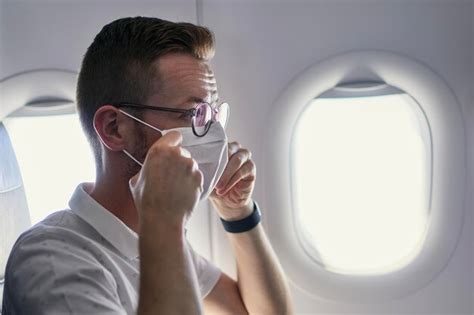 Premium Photo Passenger Wearing Protective Face Mask In Airplane