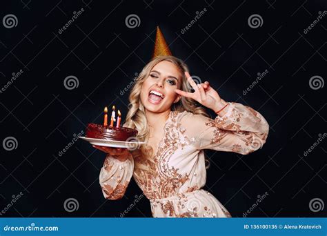 Portrait Of A Young Beautiful Blond Girl Holding Birthday Cake With Candles And Having Fun On