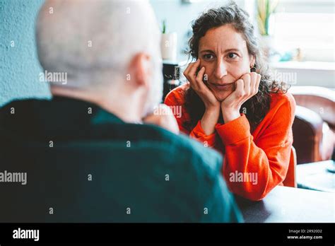 Woman Leaning On Elbows Staring At Man Stock Photo Alamy