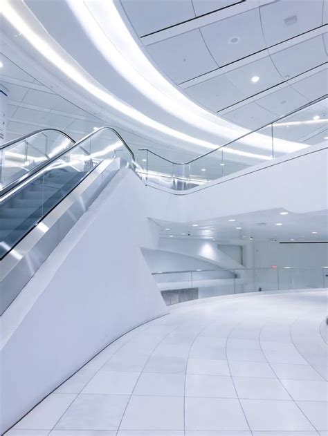 Futuristic Escalator in White Building