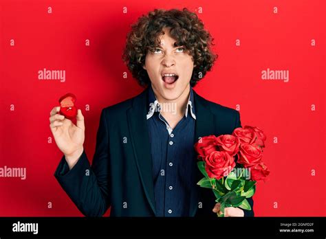 Handsome Young Man Holding Bouquet Of Flowers And Engagement Ring Angry