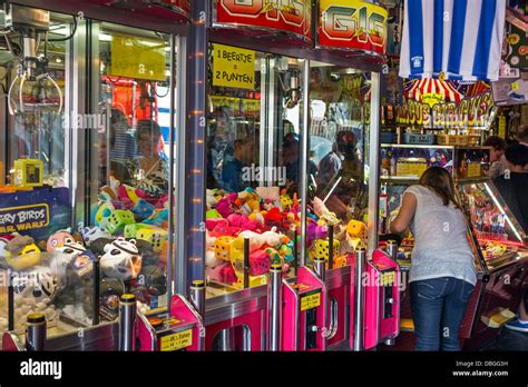 Arcade With Claw Crane Game Machines Filled With Toys And Coin Pusher