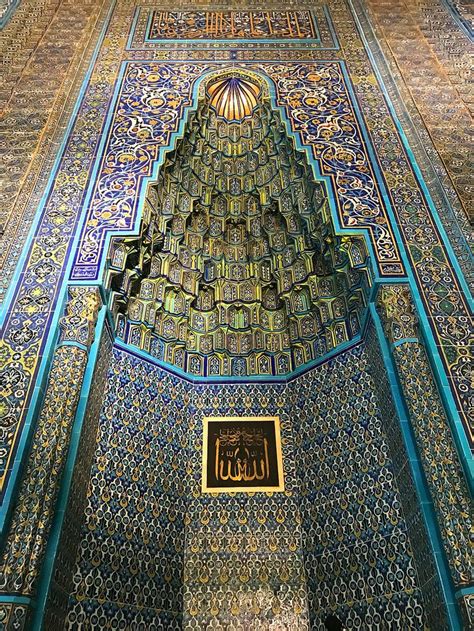 The Inside Of An Ornate Building With Blue And Gold Tiles