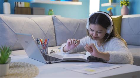 Cheerful young girl studying while listening to music. 32507817 Stock ...