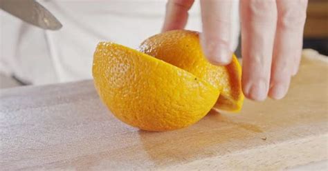 Close Up Of A Chef Knife Peeling And Slicing An Orange Chef Knife