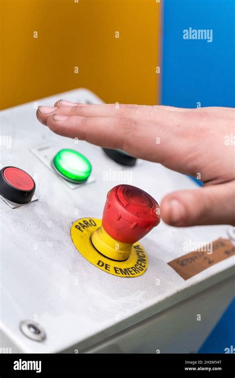 Hand Pressing The Red Emergency Button Or Stop Button For Industrial