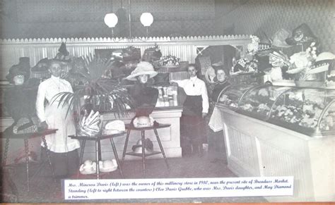 An Old Black And White Photo Of People In A Store