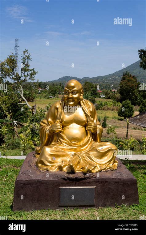 fat monk statue in complex Pagoda Ekayana Stock Photo - Alamy