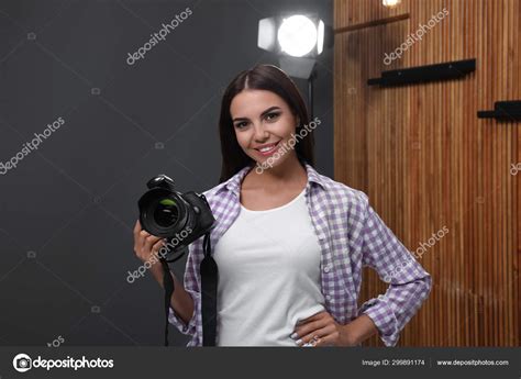 Professional photographer with modern camera in studio — Stock Photo ...