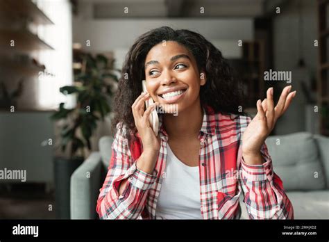 Happy Pretty Millennial Black Lady Calling By Smartphone Talking With