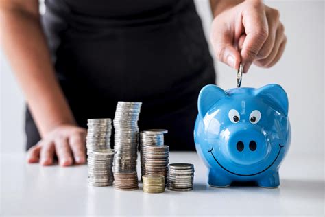 Person putting money into piggy bank 1226830 Stock Photo at Vecteezy