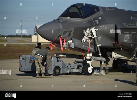 A U S Air Force Weapons Load Crew Assigned To The 33rd Aircraft