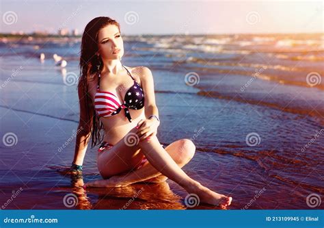 Fashion Model In American Flag Bikini Swimwear Relax On The Beach Wallpaper Stock Image