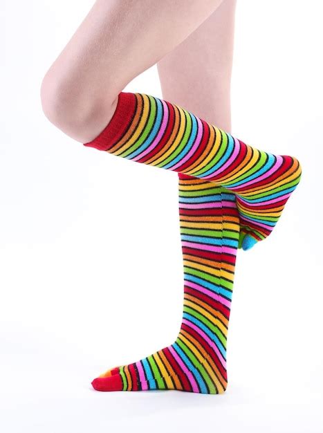 Premium Photo | Female legs in colorful striped socks isolated on white