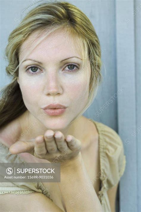 Woman Blowing Kiss At Camera Superstock