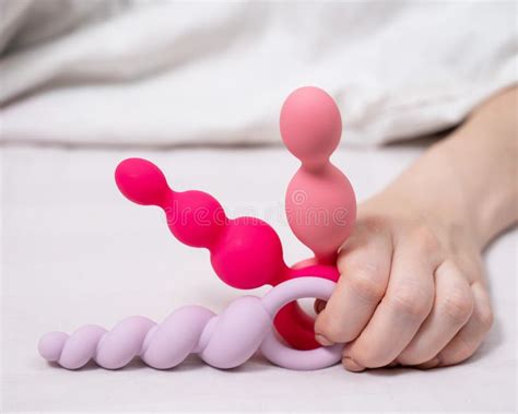 Woman Holding Three Different Anal Beads While Lying In Bed Stock Photo Image Of Plug