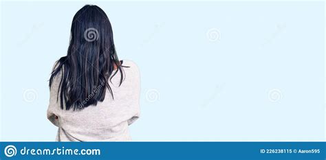 Hispanic Woman With Long Hair Wearing Casual Clothes Standing Backwards