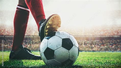 feet of soccer player tread on soccer ball for kick-off in the stadium Stock Photo | Adobe Stock