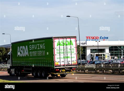 Asda Articulated Lorry Travelling Past The Tesco Extra Supermarket