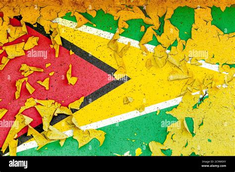 The National Flag Of Guyana Is Painted On An Old Metal Wall With Ragged Paint Country Symbol