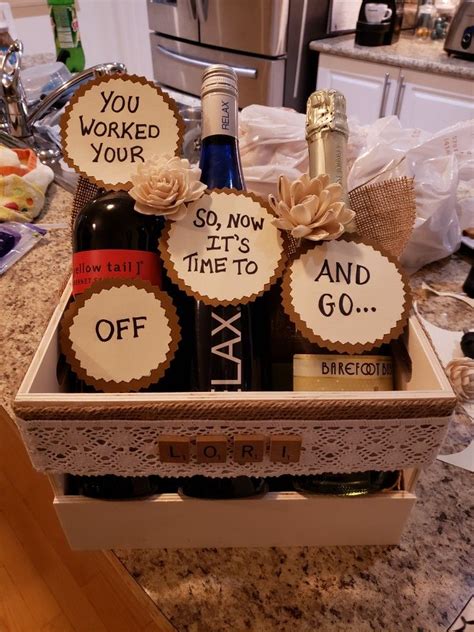 Bottles Of Wine In A T Box On A Kitchen Counter With Tags That Say