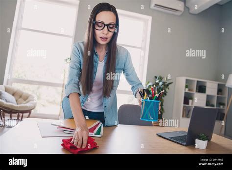 Photo Of Optimistic Brunette Millennial Lady Clean Table Wear Jeans