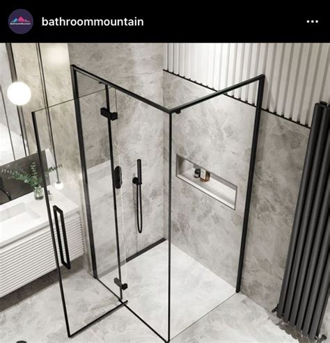 A Bathroom With A Walk In Shower Next To A Sink