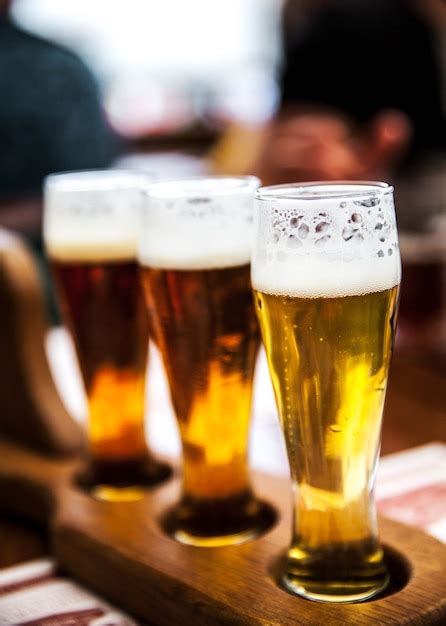 Premium Photo Glass Of Beers On Wooden Table