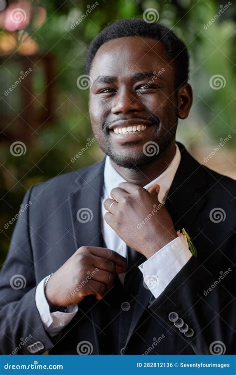 Smiling Black Man Getting Ready For Wedding Ceremony Stock Photo