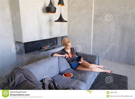 Dazzling Blonde Uses Smartphone And Tries Ripe Strawberry Sitti Stock Image Image Of