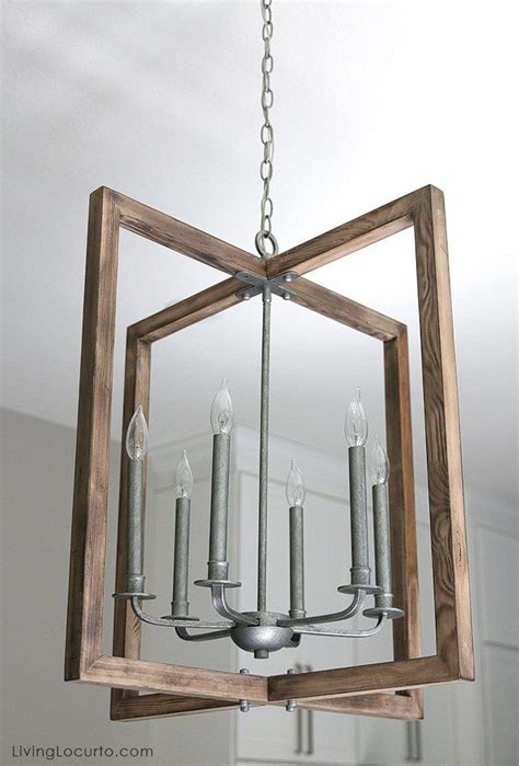 a chandelier hanging from the ceiling in a room with white walls and ...