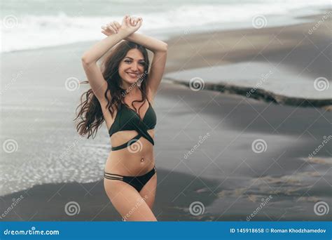 Smiling Brunette Girl In Swimsuit Posing On Black Sand Beach Stock Photo Image Of Legs Bali