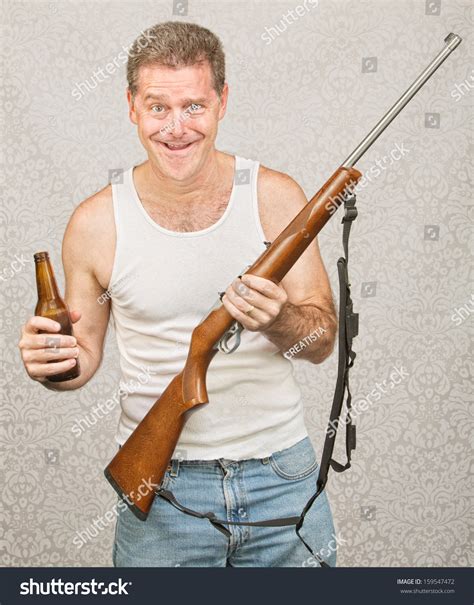 Single Male Hillbilly Holding Beer And Rifle Stockfoto 159547472