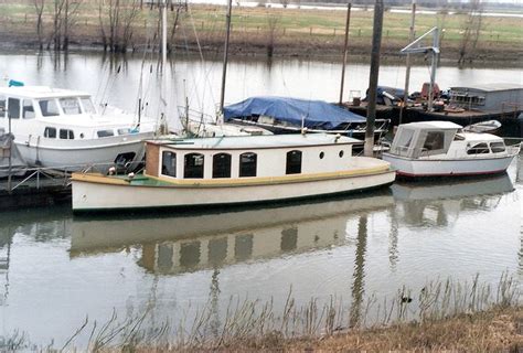 Two Boats Are Docked In The Water Next To Each Other