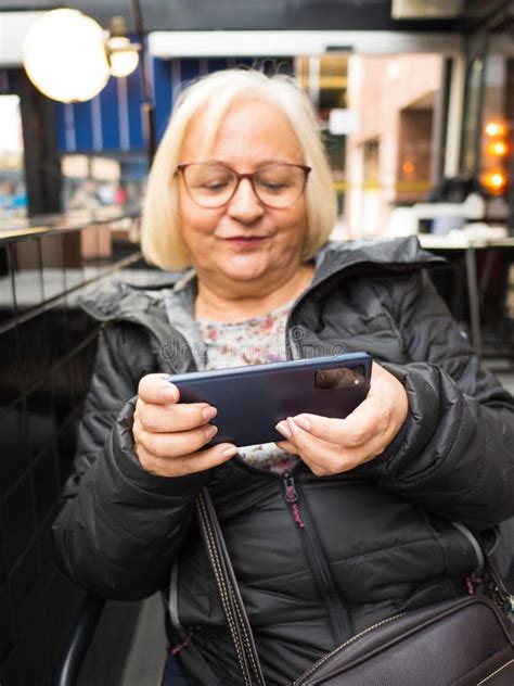 Defocused Blonde Gamer Grandmother Very Concentrated Playing On Smartphone Stock Image Image