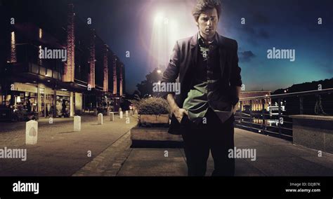 Sad handsome man walking alone at the night Stock Photo - Alamy