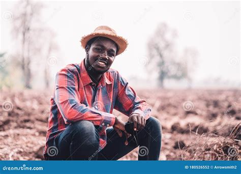 African Man Farmer Sitting On The Field Stock Photo Image Of Sitting