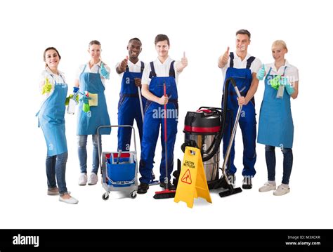 Group Of Happy Janitors Gesturing Thumbs Up On White Background Stock