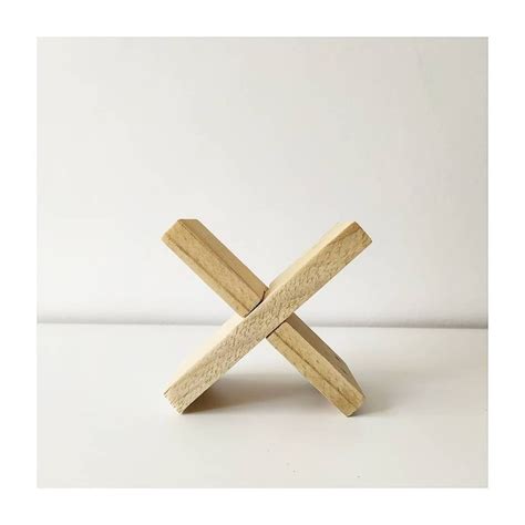 A Wooden Cross Sitting On Top Of A White Table