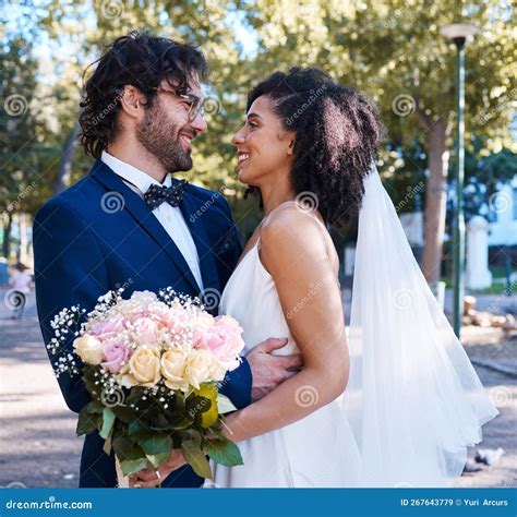 Interracial Wedding And Couple With Flowers And Hug At Romantic Outdoor