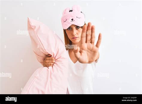 Beautiful Redhead Woman Wearing Sleeping Mask Cuddling Pink Pillow Over