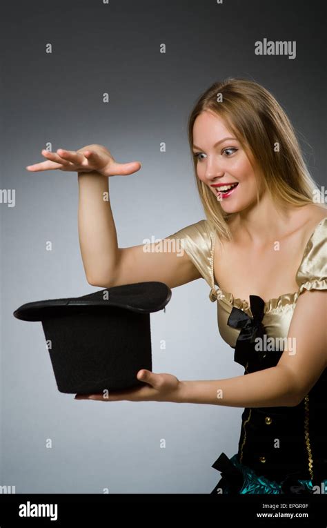 Woman magician with magic wand and hat Stock Photo - Alamy