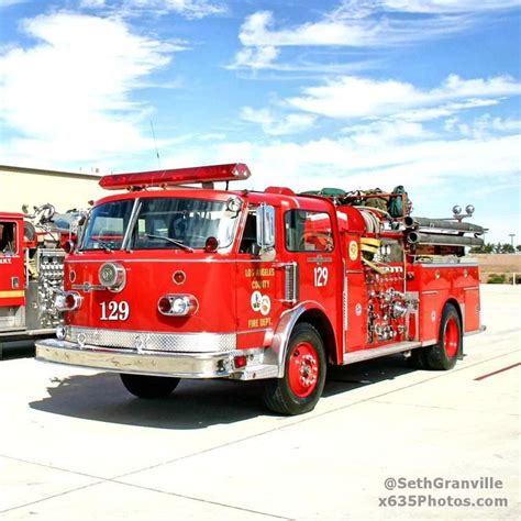 Two Fire Trucks Parked In Front Of A Building