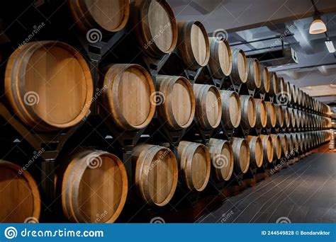 Old Aged Traditional Wooden Barrels With Wine In A Vault Lined Up In