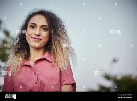 Attractive Blonde Woman With Curly Hair And Great Copy Space For Ad With A Pink Dress Stock